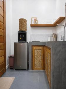 a kitchen with a refrigerator and a microwave on top of it at White Palm Villa 1 in General Luna