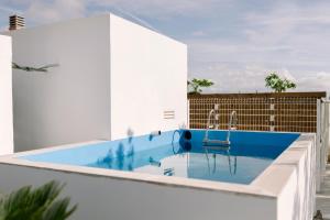 a swimming pool on the roof of a building at Masia CHOPO in L'Aldea
