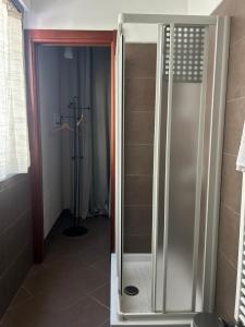 a shower with a glass door in a bathroom at Pasa da sí in Alba