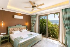 a bedroom with a bed and a large window at Payam Agora Hotel Room Only , Shared Terrace & Kitchen in Kaş