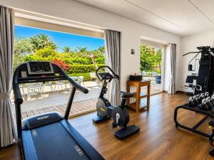 a living room with a gym with cardio equipment and a window at Domo20 Hotel & Rooftop in Vico Equense