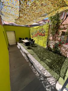 an empty room with a green wall with graffiti at Dreamers Hostel & Hotel Apartment in Yerevan