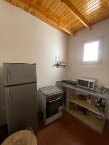 a kitchen with a refrigerator and a microwave at Bedro Private Garden Studio & Outdoor Lounge 1 Min to Sea in Dahab +5 photos