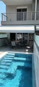 a swimming pool in front of a house at Twins house pool 1 in Nikiti