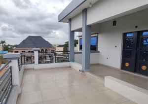 a balcony of a house with two doors at SKYFORCE Bénin - Agatha in Porto-Novo
