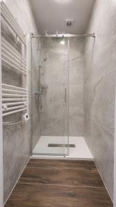 a shower with a glass door in a bathroom at Hotel Gryf in Gryfice