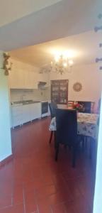 a dining room with a table and a kitchen at Da Carlo in Pietralunga