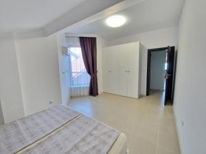 a white bedroom with a bed and a window at INFINITY VIEW 8 Lozenets in Lozenets