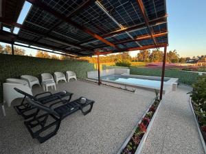 a patio with chairs and a swimming pool at Casa dos Neto Santiago in Anadia