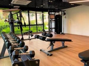 a gym with rows of exercise equipment in a room at Laya Suites and Residences in Bang Tao Beach