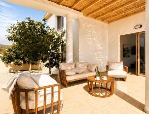 a patio with a couch and a table at Mariandy Villa 2 in Coral Bay