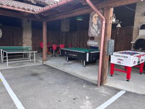 a room with a pool table and ping pong tables at Family in Envie