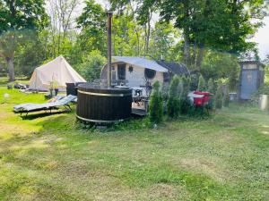 a camp site with a tent and a table and chairs at Muhu Leeni Glamping in Kuivastu +12 photos