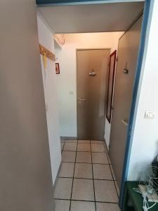 a hallway with a door and a tile floor at Port Aloès in Cerbère +9 photos
