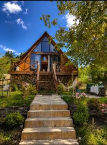 a house with stairs leading up to it at Tasia's Cottage in Tsalka