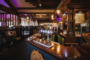 a bar in a pub with a counter top at Rogerthorpe Manor Hotel in Pontefract
