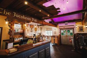 a bar in a restaurant with a purple ceiling at Rogerthorpe Manor Hotel in Pontefract