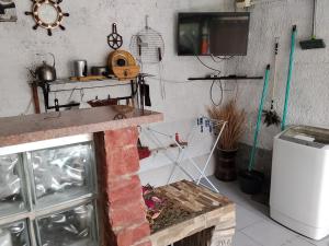 a kitchen with a fireplace and a tv on the wall at Hostel Familiar Estudiantil in Montevideo