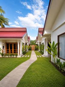 a walkway leading to a house with a yard at White Palm Villa 1 in General Luna