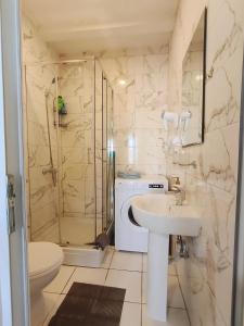 a bathroom with a sink and a shower and a toilet at Good Inn in Bar +30 photos