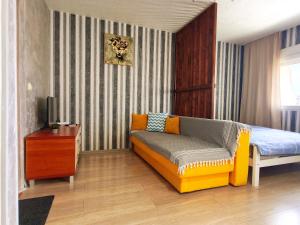 a bedroom with a bed and a couch in it at Good Inn in Bar