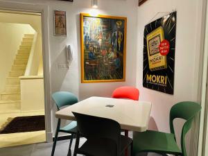 a dining room with a white table and chairs at BRIC à BRAC eclectic rooms in Uggiano la Chiesa +71 photos