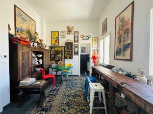 a living room with a large wooden table and chairs at BRIC à BRAC eclectic rooms in Uggiano la Chiesa