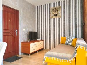 a bedroom with a bed and a tv on a dresser at Good Inn in Bar