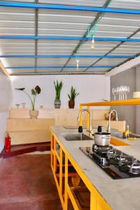 a kitchen with a sink and a stove top oven at Rooms next to Florentine with bomb shelter inside the building in Tel Aviv