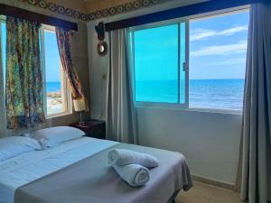 a bedroom with a bed with a view of the ocean at "Casitas Arcoiris" Excelente ubicación - Petfriendly in Isla Mujeres +65 photos