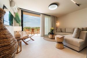 a living room with a couch and a table at Ammosphere in Nea Peramos