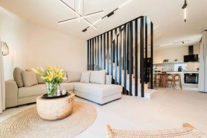 a living room with a couch and a table at Ammosphere in Nea Peramos