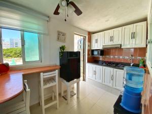 a kitchen with white cabinets and a counter top at "Casitas Arcoiris" Excelente ubicación - Petfriendly in Isla Mujeres