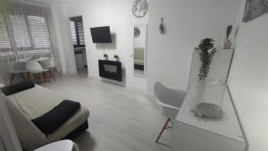a living room with a couch and a table at Sky in Noja