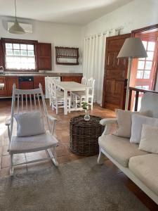 a living room with a couch and a table and chairs at La Vereda - Rural getaway, pool, golf & hiking lovers in Tacoronte