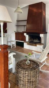 a living room with a table and a fireplace at La Vereda - Rural getaway, pool, golf & hiking lovers in Tacoronte +9 photos