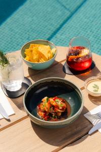 a table with a bowl of salsa and a bowl of chips at The Social Hub Madrid 4 star in Madrid