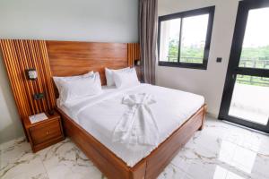 a bedroom with a bed with a bow on it at Logements Majeo in Bikondo +1 photo