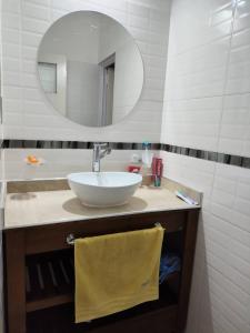 a bathroom with a sink and a mirror at Casa chalet cerca nodo y estadio in Santiago del Estero