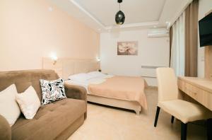 a bedroom with a couch and a bed in a room at La Hacienda in Ulcinj +248 photos