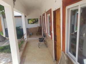 a hallway of a house with a door and a chair at baobolong ghuesthouse in Lamin Koto