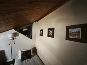 a bedroom with a bed and pictures on the wall at The Loft Getaway in Clarens