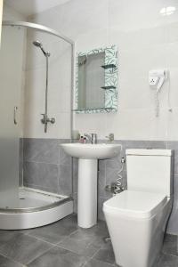 a bathroom with a toilet and a sink and a shower at Old Town Hotel in Baku +51 photos