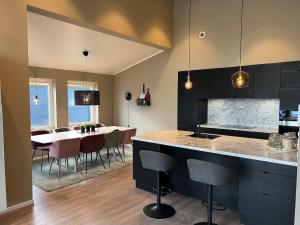 a kitchen and dining room with a table and chairs at Moderne enebolig med gratis parkering in Alta