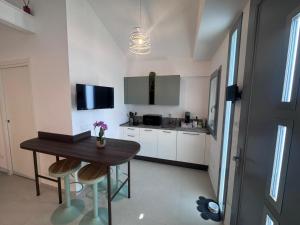 a kitchen with a wooden table and a small table with chairs at Cà in Laguna in Chioggia +12 photos