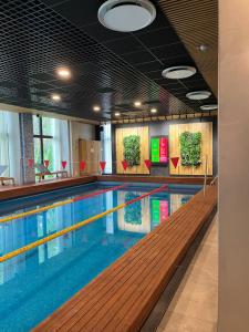 a large swimming pool in a building at Albatross Seaside Escape in Ķesterciems