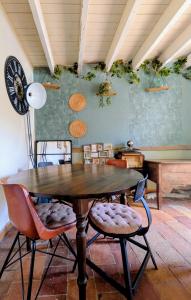 a dining room with a wooden table and chairs at Le calme de la campagne proximité Center Parcs in Saint-Léger-de-Montbrillais