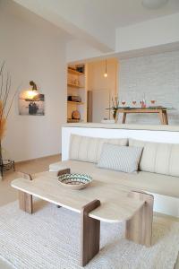 a living room with a white couch and a table at To Nisi in Loutraki