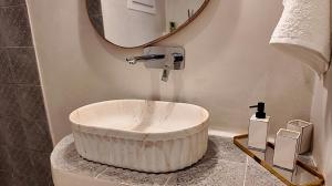 a bathroom with a large white tub on a counter at To Nisi in Loutraki +47 photos