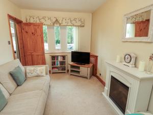a living room with a couch and a fireplace at The Haven in Morecambe